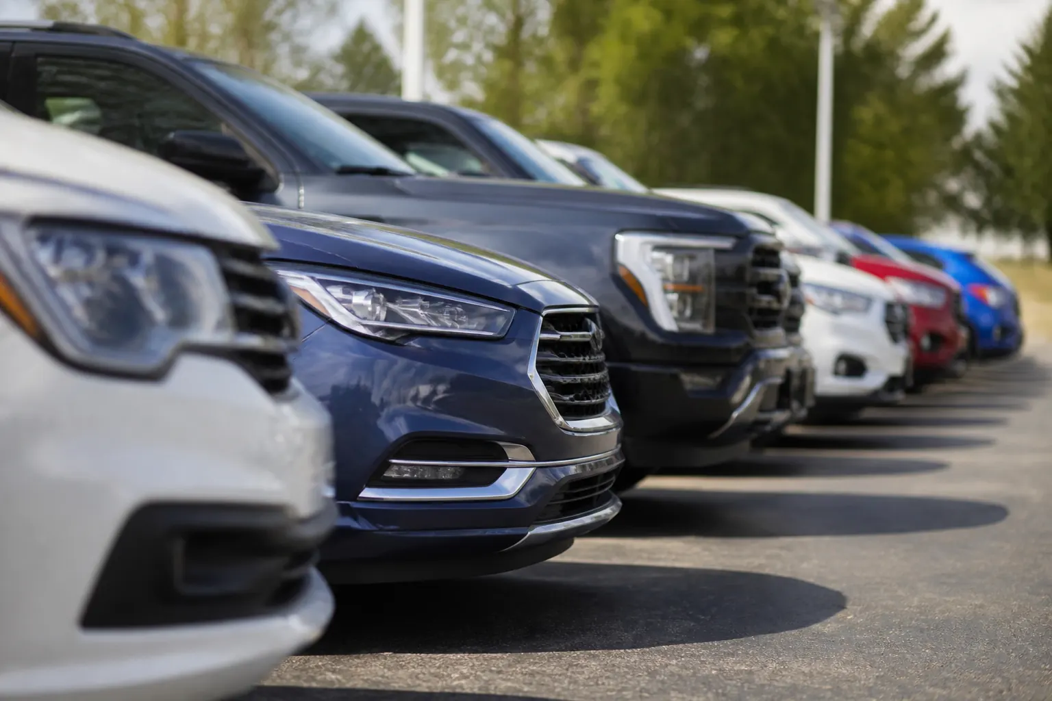 Several different cars parked in a row