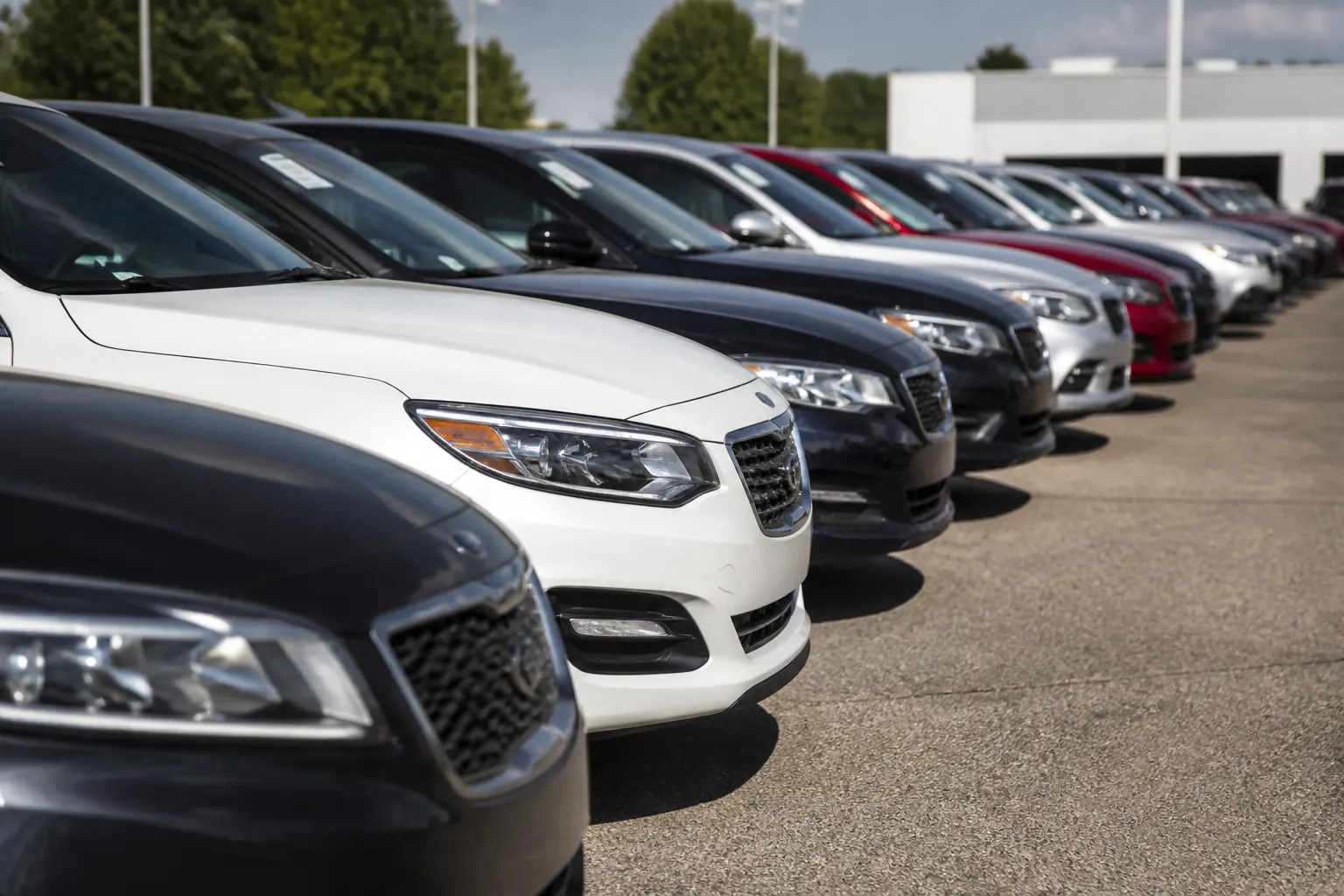 Row of certified pre-owned cars on a dealership lot